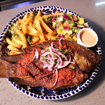 Dos Amigos Restaurant and Bar - A whole mojarra marinated in our zesty guajillo-puya chile adobo and fried to perfection. - Mexican Near Me - Stanton, California Dos Amigos Restaurant and Bar - A whole mojarra marinated in our zesty guajillo-puya chile adobo and fried to perfection. - Mexican Near Me - Stanton, California