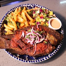 Dos Amigos Restaurant and Bar - A whole mojarra marinated in our zesty guajillo-puya chile adobo and fried to perfection.