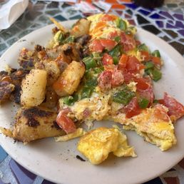 3 egg omelette with cheese tomatoes and peppers, home fries.