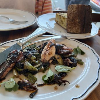 Sfizio - grilled squid with scallion and salsa negra, $3 grilled bread in the background - Italian Near Me - Oakland, California Sfizio - grilled squid with scallion and salsa negra, $3 grilled bread in the background - Italian Near Me - Oakland, California