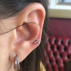TLC Tattoo - High lobe piercing by Mara, installed with a Swarovski crystal cluster from Industrial Strength.