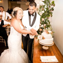 Finesse Events & Services - Beautiful bride and groom cutting their cake.