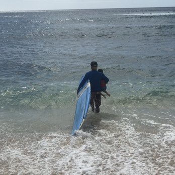 North Shore Surf Lessons - Kala carrying my son out. - Surf Schools Near Me North Shore Surf Lessons - Kala carrying my son out. - Surf Schools Near Me