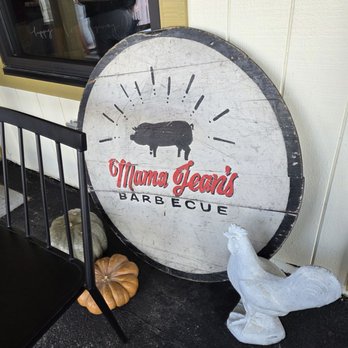 Mama Jean's - The Mama Jean's BBQ Restaurant sign next to a window in front of the restaurant. - Barbeque Near Me - Roanoke, Virginia