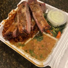 Smoked pork ribs, jollof rice, beans, and collard greens Smoked pork ribs, jollof rice, beans, and collard greens