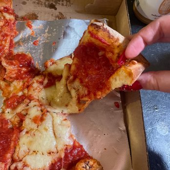 Tony and Ann's Pizza - a person taking a slice of pizza - Pizza Near Me - Dracut, Massachusetts Tony and Ann's Pizza - a person taking a slice of pizza - Pizza Near Me - Dracut, Massachusetts