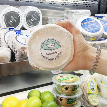 Picnic & Pantry - a person's hand holding a piece of cheese - Grocery Near Me - Somerville, Massachusetts Picnic & Pantry - a person's hand holding a piece of cheese - Grocery Near Me - Somerville, Massachusetts