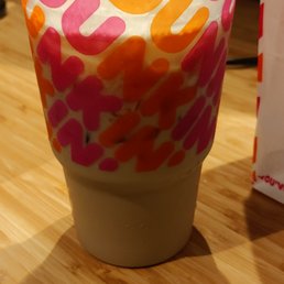  a plastic cup on a wooden table