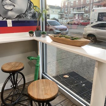 Spread Love and Juice - a table with two stools in front of a window - Juice Bars & Smoothies Near Me - Brooklyn, New York Spread Love and Juice - a table with two stools in front of a window - Juice Bars & Smoothies Near Me - Brooklyn, New York