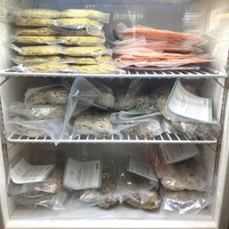 Mini freezer of grab-and-go grocery items (salmon burger patties, cookie doughs, etc.)