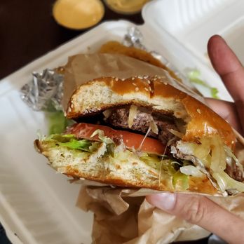 Calibun - a person holding a sandwich in their hand - Burgers Near Me - Queens, New York Calibun - a person holding a sandwich in their hand - Burgers Near Me - Queens, New York