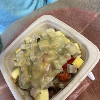Mercantile - Breakfast Bowl - A breakfast bowl in a takeout container contains scrambled eggs, vegetables, and is topped with gravy. - Bakeries Near Me - Dennis, Massachusetts