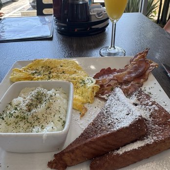 Tulua Bistro - Springfield platter: grits, eggs, bacon and a warm biscuit or sub for pancakes/french toast. - Breakfast & Brunch Near Me - Jacksonville Beach, Florida Tulua Bistro - Springfield platter: grits, eggs, bacon and a warm biscuit or sub for pancakes/french toast. - Breakfast & Brunch Near Me - Jacksonville Beach, Florida