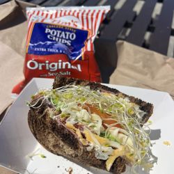 Avocado, cheese, sprout, & tomato with salami on dark rye