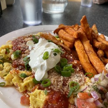 Studio One Cafe - The Spanish Dancer - A breakfast plate featuring scrambled eggs topped with sour cream, green onions, and cheese, served with fries and a side of salsa. - Breakfast & Brunch Near Me - Eugene, Oregon