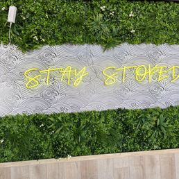 a sign in front of a green wall a sign in front of a green wall