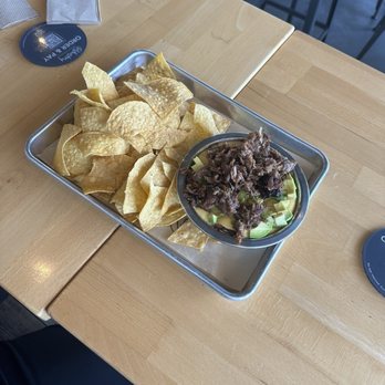 Industry - Green Chile Queso with Brisket - New American Near Me - San Marcos, Texas