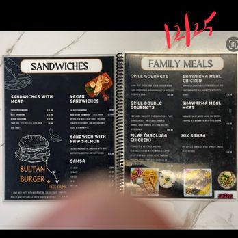 Sultan - Menu of sandwiches and family-size meals (Dec 2025) - Menu from Sultan restaurant in Breezewood, PA, displaying sections for sandwiches, vegan sandwiches, and family meals. The sandwich menu includes chicken shawarma, meat shawarma, kebab, and taco bell, with prices ranging from $9.99 to $12.99. Vegan options include falafel and vegetarian shawarma. The family meals section offers grilled gourmets, shawarma chicken, shawarma meat, and a pilaf chicken dish, with prices from $14.99 to $49.99. Handwritten date 12/25 is written in red at the top right corner of the menu. The menu is printed on black and white backgrounds with some images of food at the bottom. - Falafel Near Me - Breezewood, Pennsylvania