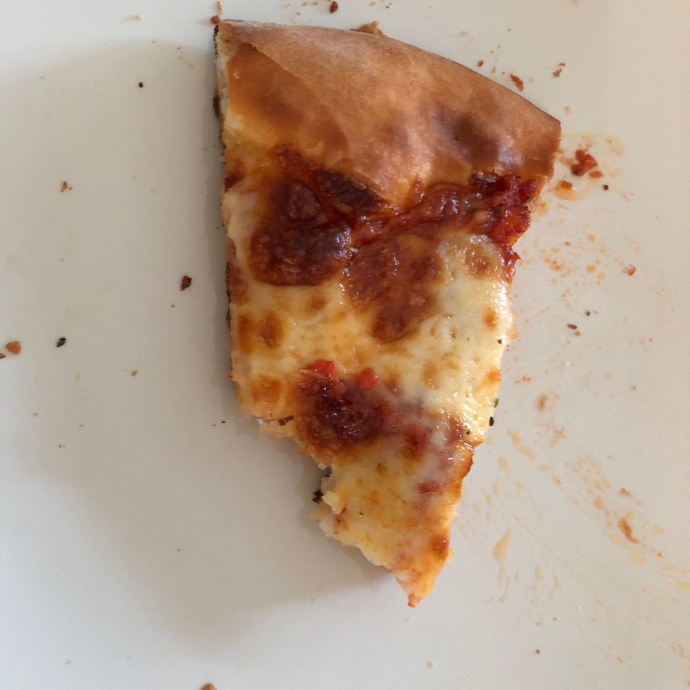 a slice of pizza on a plate a slice of pizza on a plate
