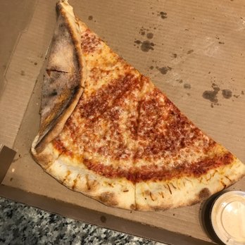 Cosmo’s Pizza - How it arrived- crust folded by box. Notice the lack of cheese and the sauce showing. Pizza was bland - Pizza Near Me - Lafayette, Colorado