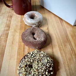 Walnut chocolate frosted, cinnamon apple, glazed molasses donuts.