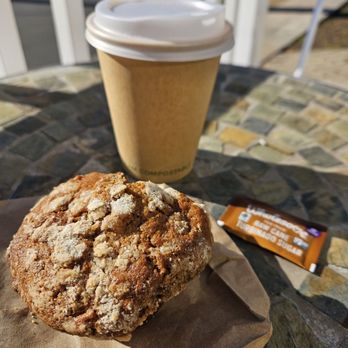 The Hudson Oven - Outdoor patio seating, featuring an apple oat muffin, small coffee in a compostable cup, and fair trade raw sugar packet - Bakeries Near Me - Croton-on-Hudson, New York The Hudson Oven - Outdoor patio seating, featuring an apple oat muffin, small coffee in a compostable cup, and fair trade raw sugar packet - Bakeries Near Me - Croton-on-Hudson, New York