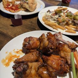 Front: Mango Habanero Wings, Middle: Texas Style Fries, Back: Cowboy Dog with fries. Front: Mango Habanero Wings, Middle: Texas Style Fries, Back: Cowboy Dog with fries.