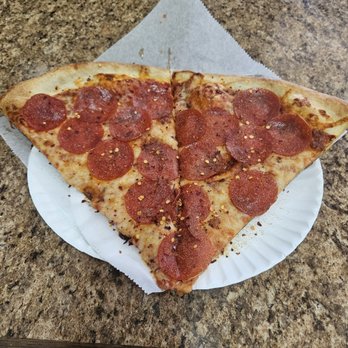 Famous Ray's Pizza - Two slices of pepperoni pizza with garlic powder and pepper flakes. - Pizza Near Me - Phoenix, Arizona Famous Ray's Pizza - Two slices of pepperoni pizza with garlic powder and pepper flakes. - Pizza Near Me - Phoenix, Arizona