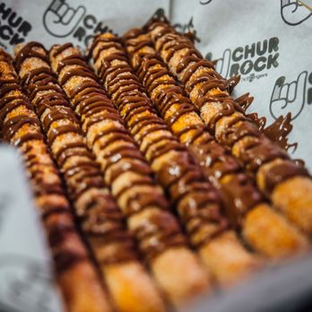 Vfingers - a close up of a box of doughnuts - Venezuelan Near Me - Katy, Texas