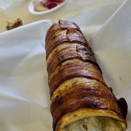 A big burrito with bacon. A big burrito with bacon.