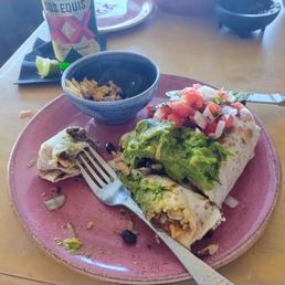 Grilled chicken El burrito with guacamole and tomato onions cilantro Grilled chicken El burrito with guacamole and tomato onions cilantro