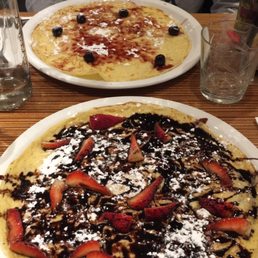 Dutch pancake with Chocolate sauce and strawberries and a blueberry syrup pancake