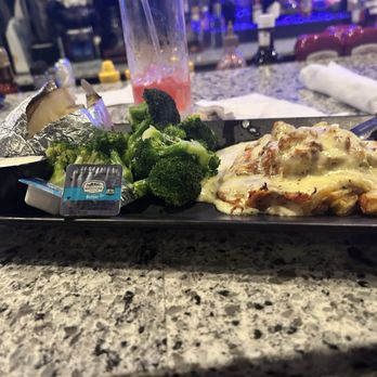 Flinchy's - This was a special-Chicken topped with crab meat with a creamy lemon sauce baked potato and broccoli - New American Near Me - Camp Hill, Pennsylvania
