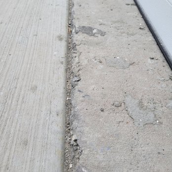 Highland Homes - Concrete crumbling at edge of garage. - Real Estate Services Near Me - Lakeland, Florida Highland Homes - Concrete crumbling at edge of garage. - Real Estate Services Near Me - Lakeland, Florida
