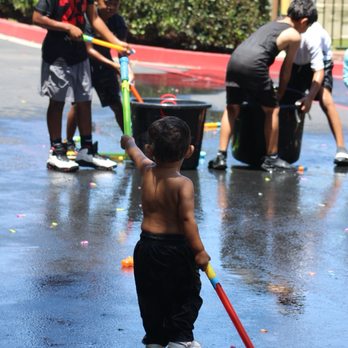The Crossing Church - Son playing on water day - Churches Near Me - Costa Mesa, California