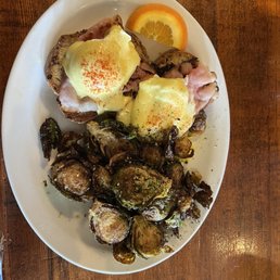 Eggs Benedict on a gluten free bun with Brussels sprouts. Eggs Benedict on a gluten free bun with Brussels sprouts.