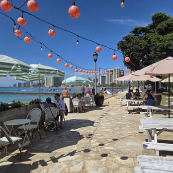 Barefoot Beach Cafe - Barefoot Cafe seating area with mimic tables and umbrellas - Breakfast & Brunch Near Me - Honolulu, Hawaii