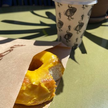 Dodo Bird Donuts - Passion mango glaze donut and spring cleanse drink (dont get the drink was just hot water with lemon) - Donuts Near Me - La Jolla, California