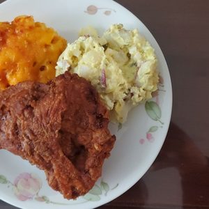 Photo of Gus’s World Famous Fried Chicken - Oakland, CA, United States. Potato salad, Mac and cheese with breast piece