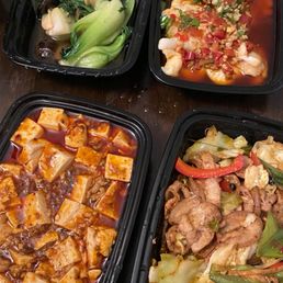 four takeout containers of food