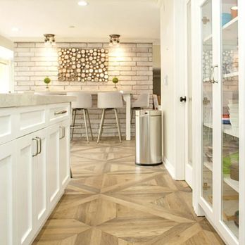 Nexxus Remodeling - a kitchen with white cabinets and wood floors - General Contractors Near Me Nexxus Remodeling - a kitchen with white cabinets and wood floors - General Contractors Near Me