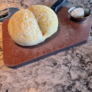 Firebirds Wood Fired Grill - Bread and butter- the bread is very hard to cut into - Steakhouses Near Me - Lees Summit, Missouri