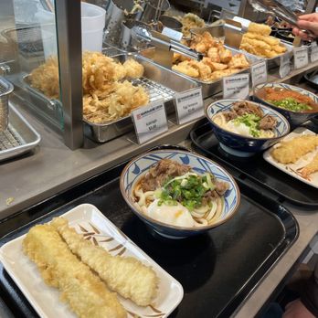 Marugame Udon - Nikutame udon in foreground - Japanese Near Me - Vancouver, British Columbia Marugame Udon - Nikutame udon in foreground - Japanese Near Me - Vancouver, British Columbia
