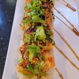 Ceo Roll- seared salmon, cream cheese inside shrimp, avocado,topped with Covington sauce and green onion, puts Trump roll to shame!