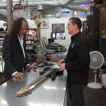 Uncle Dan's Pawn - East Dallas - Our Manager, Joe, writing a loan on a guitar to a customer of ours. - Pawn Shops Near Me - Dallas, Texas Uncle Dan's Pawn - East Dallas - Our Manager, Joe, writing a loan on a guitar to a customer of ours. - Pawn Shops Near Me - Dallas, Texas