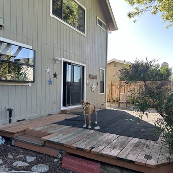 Honey Construction  - Original deck with rot, mismatched replacement boards, a tiny step coming out the slider and tiny step coming to the lawn. - General Contractors Near Me