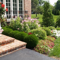 Tehandon Landscapes & Trees - A dynamic front landscape frames this front entry, inviting visitors closer.