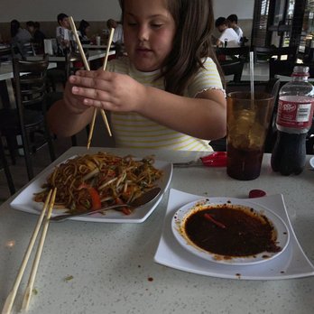 Noodle Master - Grand daughter using Chop sticks with fried noodles with shrimp. - Noodles Near Me - Baytown, Texas