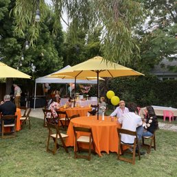 Had a groovy themed party. The yellow umbrellas and orange linens were amazing!