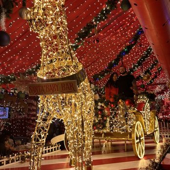 Santa Baby Bar - a gold giraffe in front of christmas lights - Bars Near Me - Chicago, Illinois